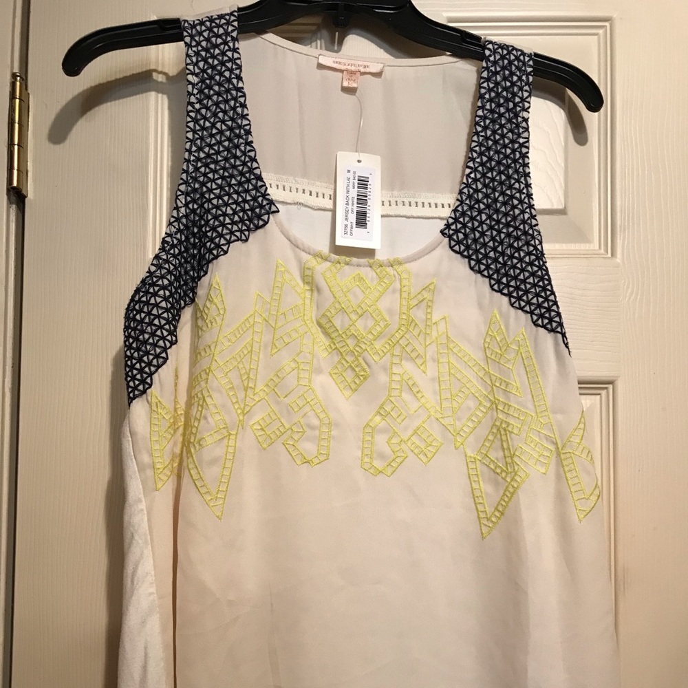 Skies are blue yellow and navy embroidery top!